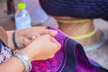 Close up hand of Hmong woman is sewing traditional tribal clothe